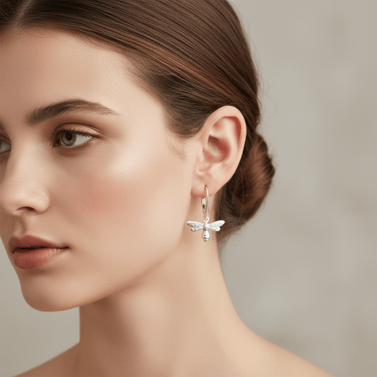Model wearing delicate sterling silver bee earrings