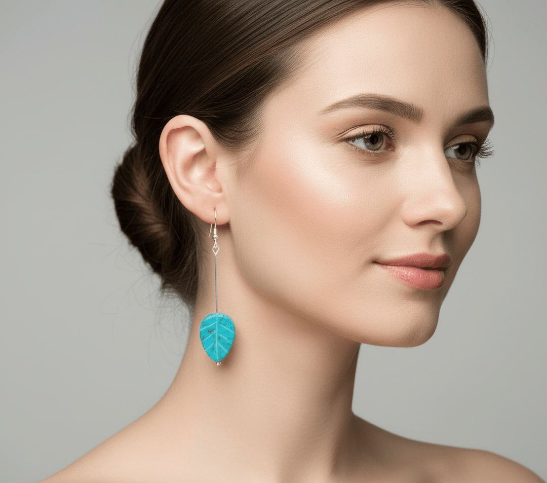 Model wearing turquoise leaf earrings
