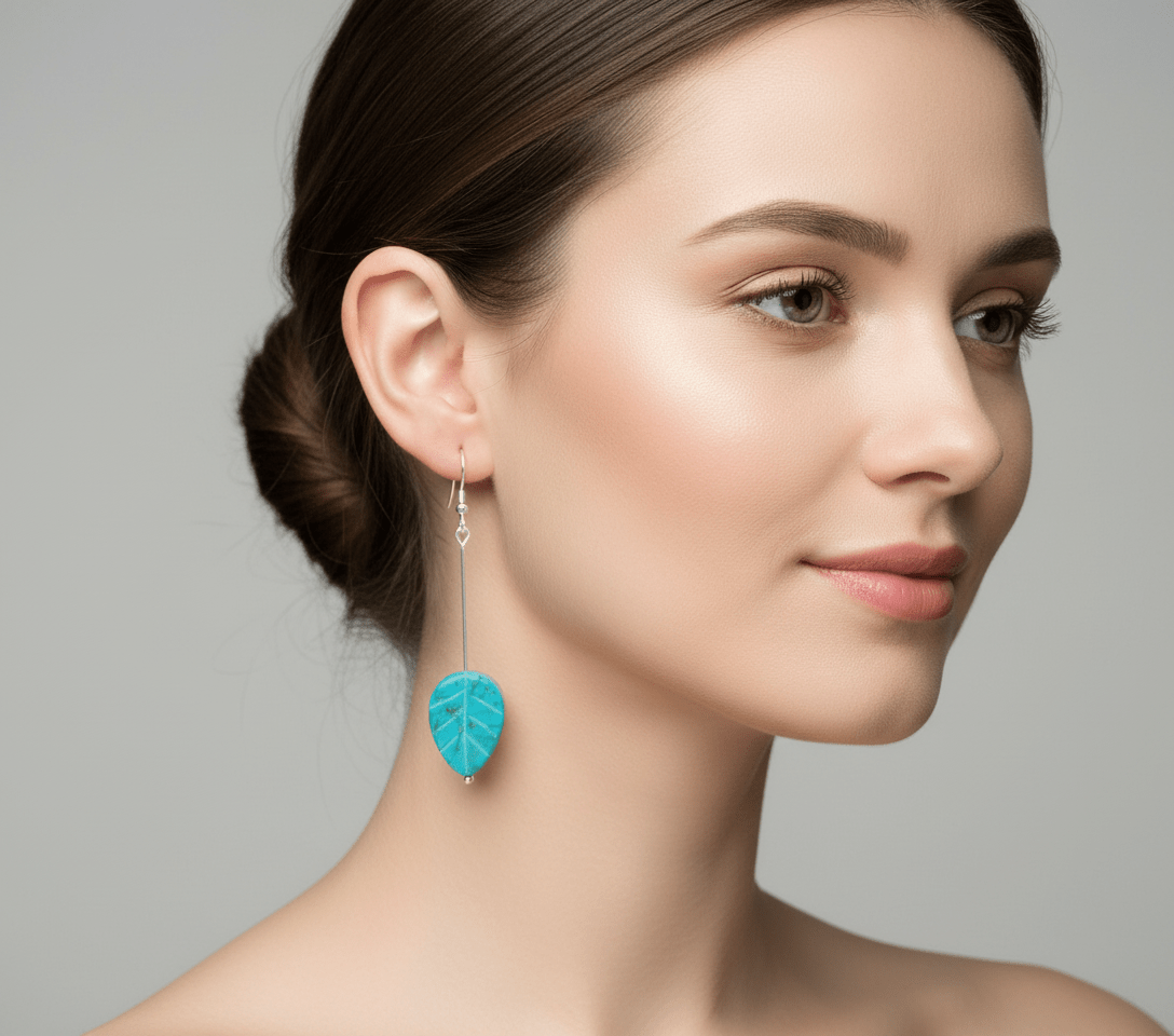 Model wearing turquoise leaf earrings