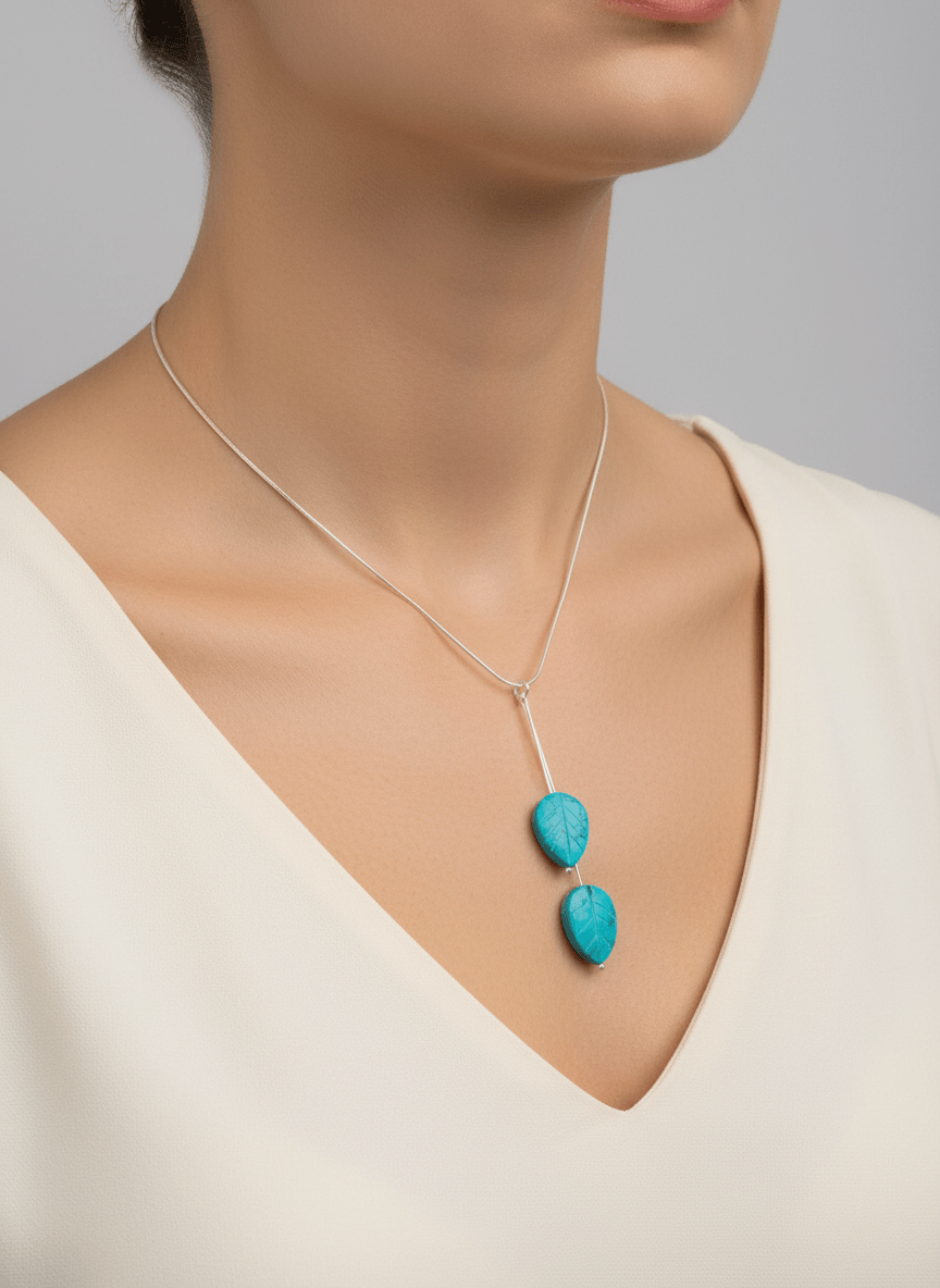 Model wearing blue magnesite carved leaf necklace on 16-inch chain