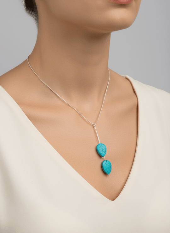 Model wearing blue magnesite carved leaf necklace on 16-inch chain