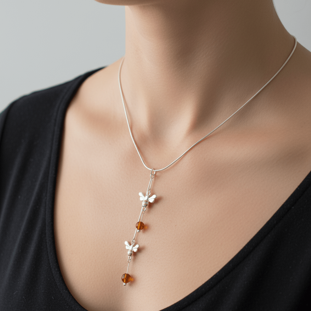 Close-up lifestyle photo of model wearing double bee and amber necklace