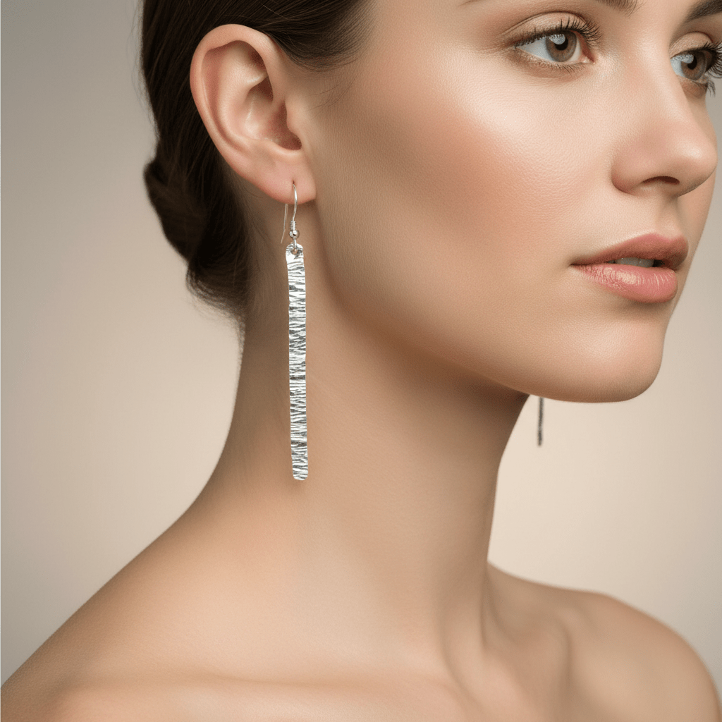 Close-up of model wearing sterling silver hammered bark texture drop earrings