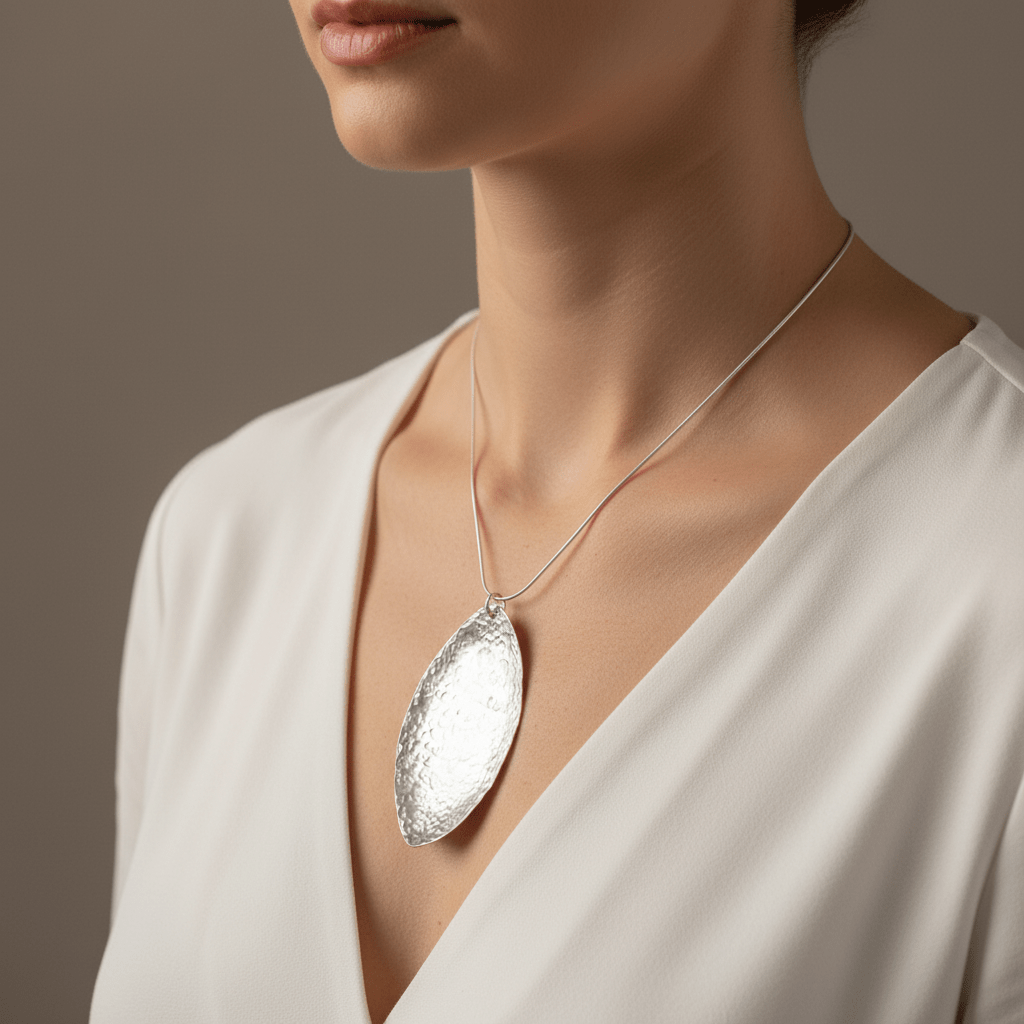 Model wearing elegant 7cm sterling silver hammered leaf necklace statement piece