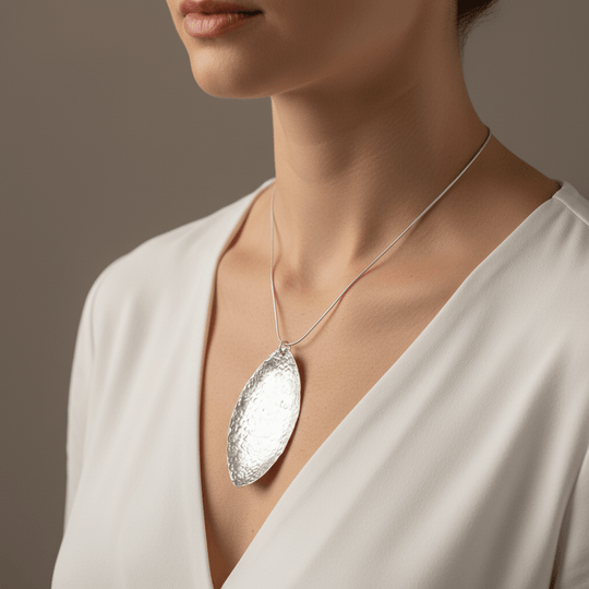 Model wearing elegant 7cm sterling silver hammered leaf necklace statement piece