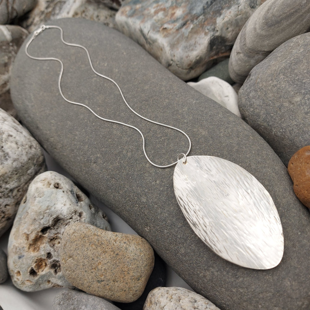 Sterling silver leaf pendant with hammered bark texture detail