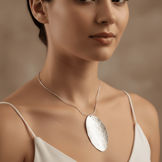 Close-up of model wearing sterling silver leaf necklace