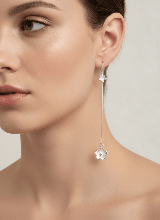 Model wearing long drop flower earrings