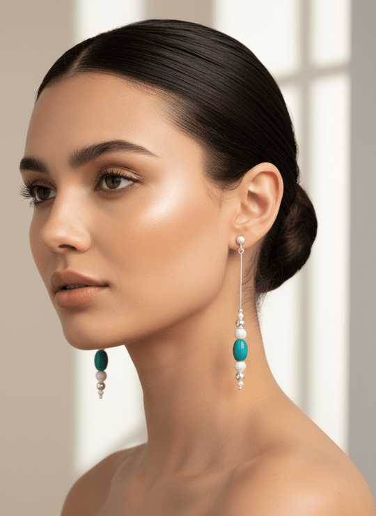 Model wearing turquoise drop earrings