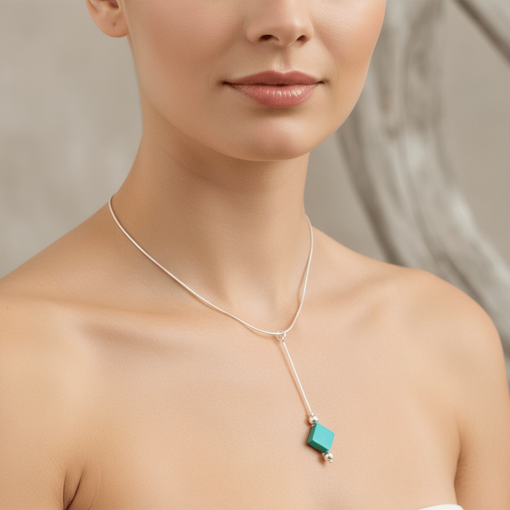 Close-up of model wearing turquoise square necklace