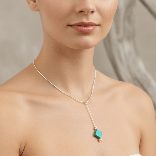 Close-up of model wearing turquoise square necklace