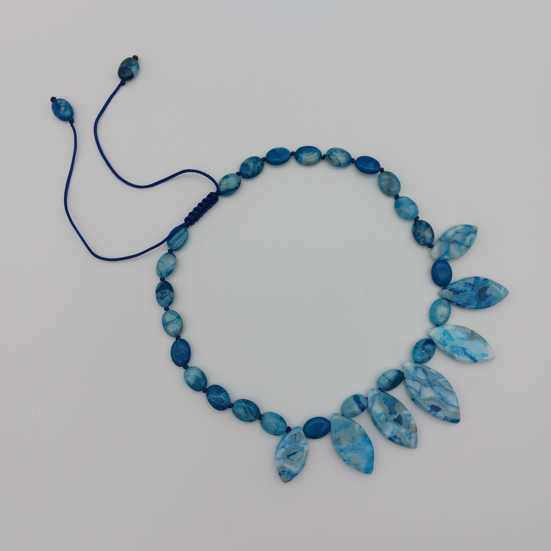 Blue Crazy Lace Agate necklace laid flat showing gemstone design and adjustable cord