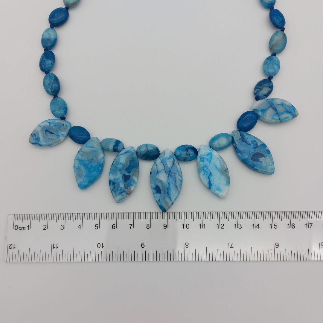 Marquise Blue Crazy Lace Agate gemstone drops beside ruler showing approximate size