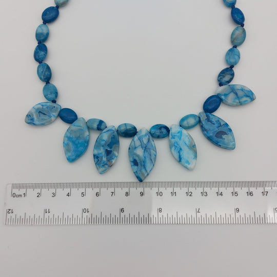 Marquise Blue Crazy Lace Agate gemstone drops beside ruler showing approximate size