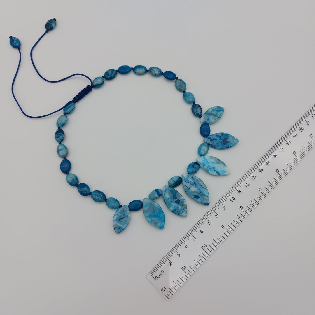 Blue Crazy Lace Agate statement necklace beside ruler showing overall size