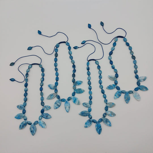 Four handmade Blue Crazy Lace Agate necklaces showing natural variations in the gemstones