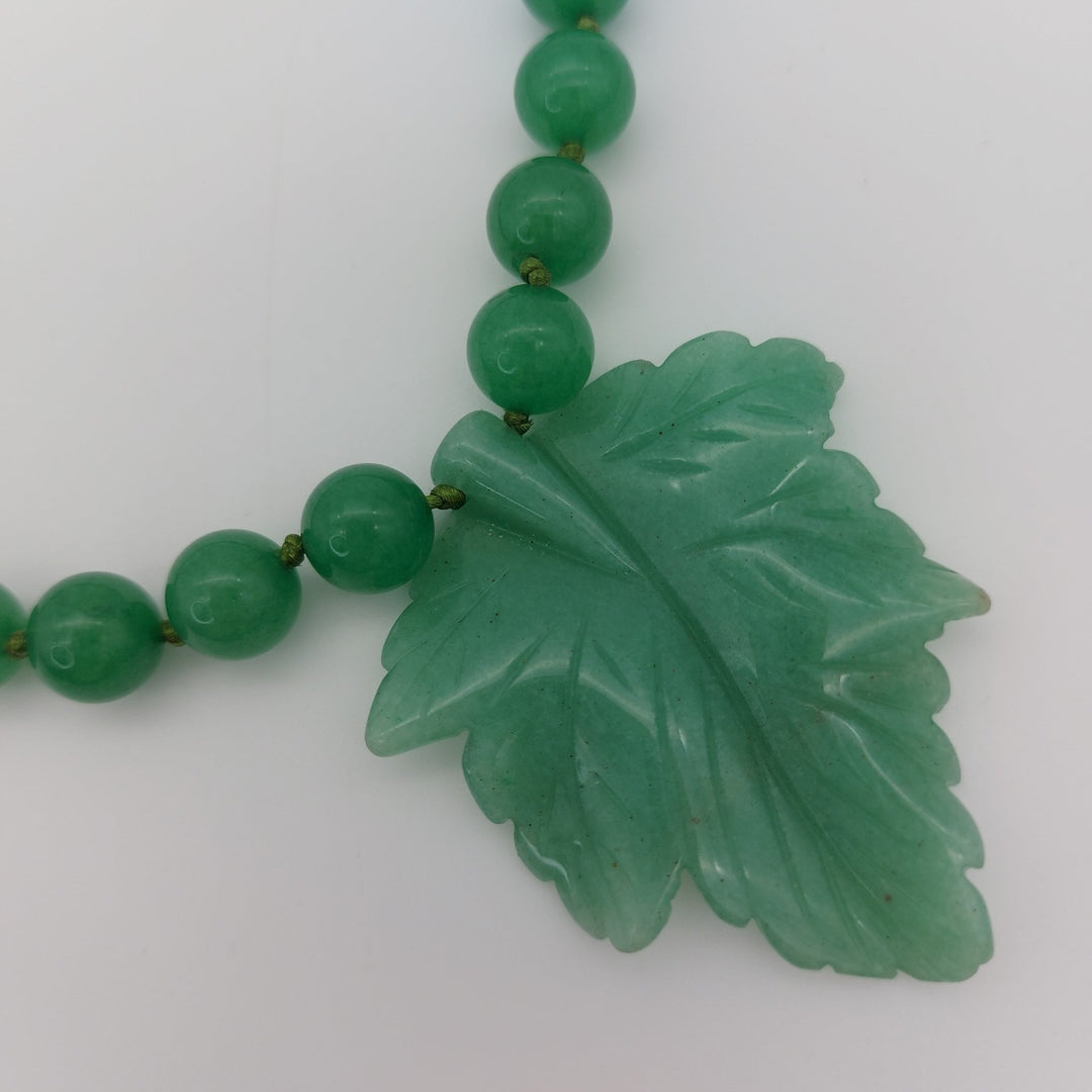 Detailed close-up of genuine green aventurine carved leaf showing natural colour and markings
