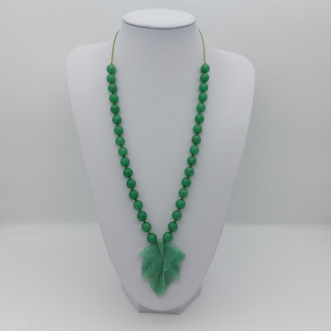 Green aventurine carved leaf adjustable necklace displayed at a longer length