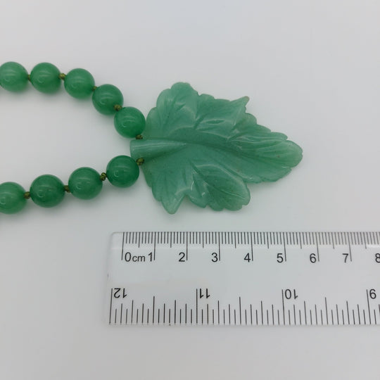 Close-up measurement of genuine green aventurine carved leaf pendant approximately 60 by 50mm
