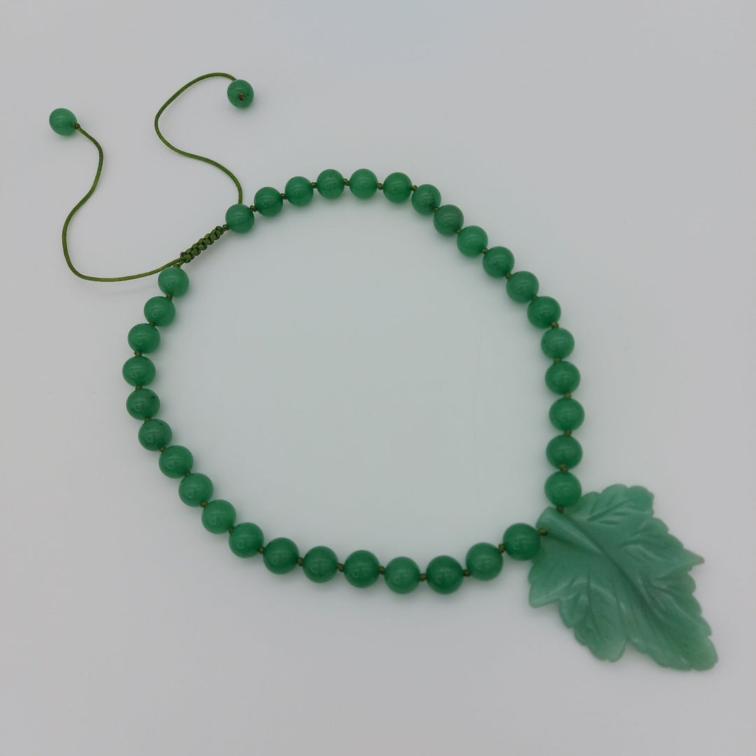 Handmade green aventurine statement necklace with carved botanical leaf pendant and round gemstone beads