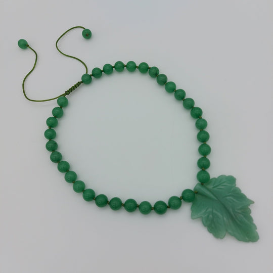 Handmade green aventurine statement necklace with carved botanical leaf pendant and round gemstone beads