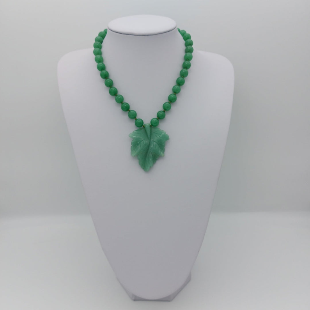 Handmade green aventurine carved leaf necklace displayed at a shorter adjustable length