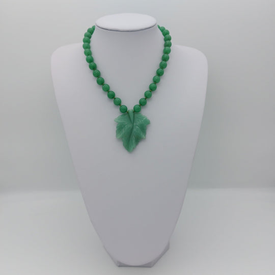 Handmade green aventurine carved leaf necklace displayed at a shorter adjustable length