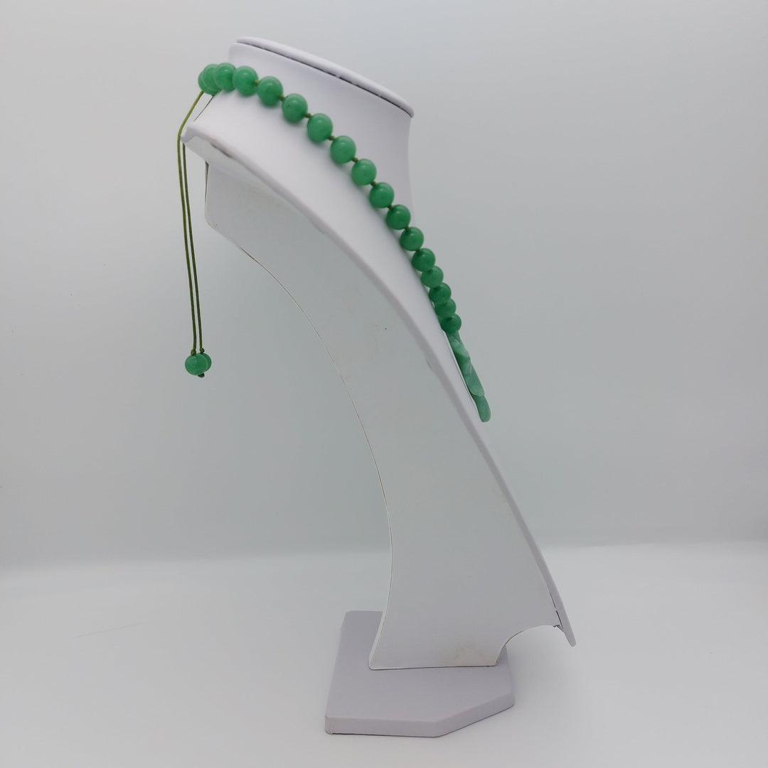 Side view of handmade green aventurine necklace showing adjustable slider fastening and hand-knotted construction