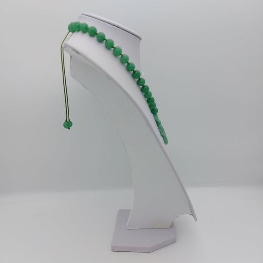 Side view of handmade green aventurine necklace showing adjustable slider fastening and hand-knotted construction