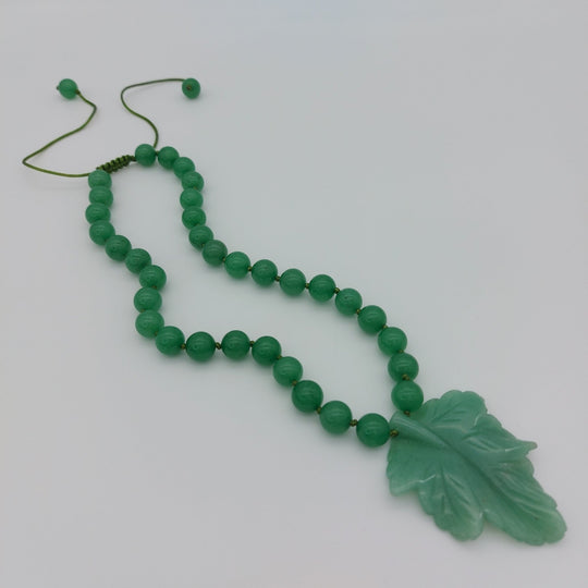 Full handmade green aventurine carved leaf necklace showing hand-knotted beads and adjustable slider