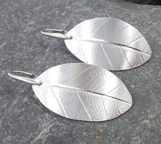 Large sterling silver leaf textured earrings front view, handmade hallmarked UK jewellery 5cm length