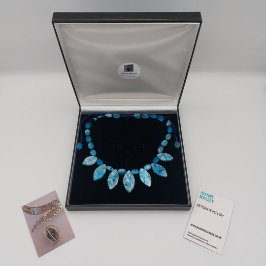 Blue Crazy Lace Agate statement necklace displayed inside jewellery presentation box