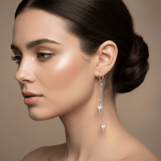 Close-up of model wearing sterling silver double drop seed caged white pearl earrings - hero image