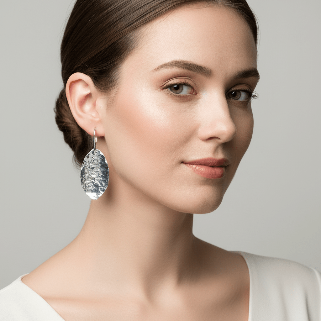 Model wearing hammered silver leaf earrings