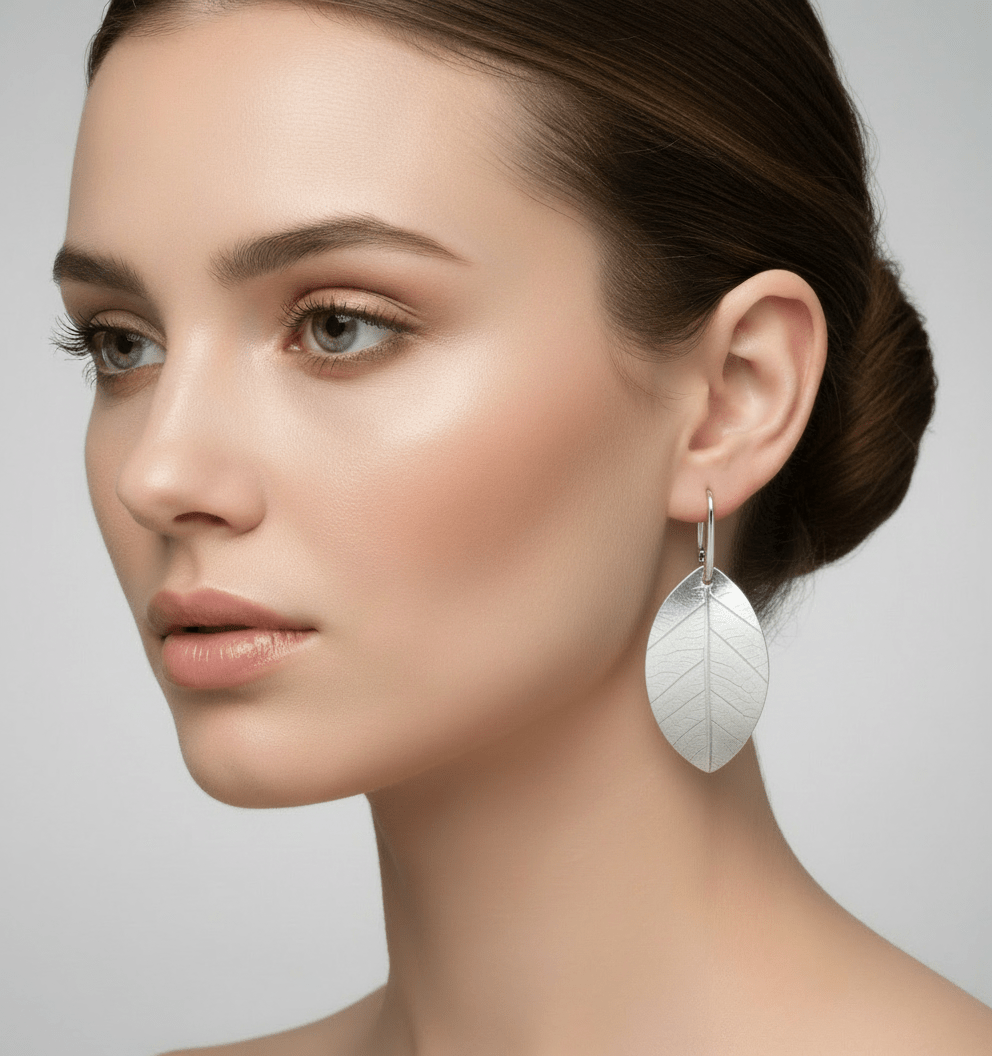 Model wearing sterling silver leaf earrings - cleaned version