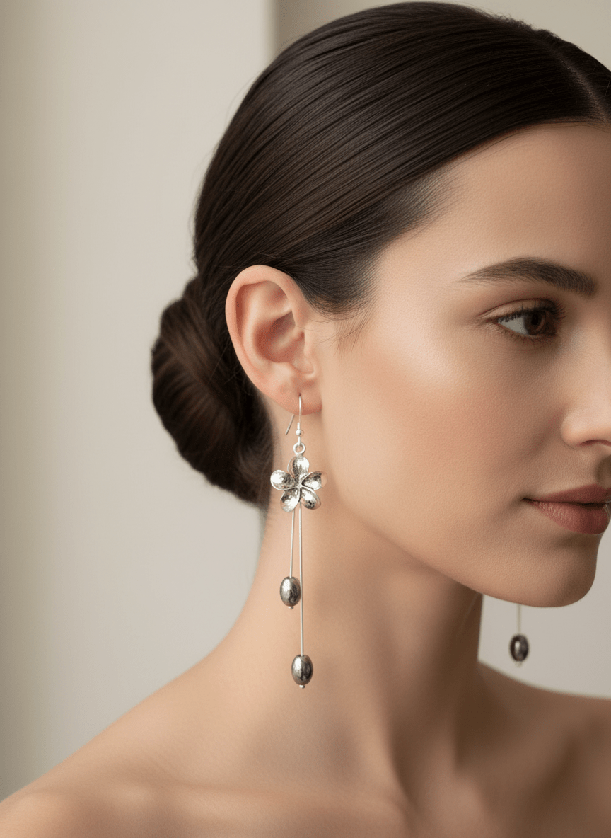 Close-up model wearing flower and hematite drop earrings