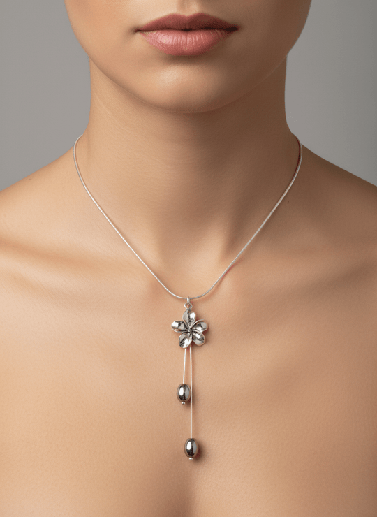 Model wearing sterling silver flower and hematite necklace