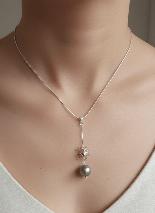 Model wearing sterling silver spider and pearl necklace